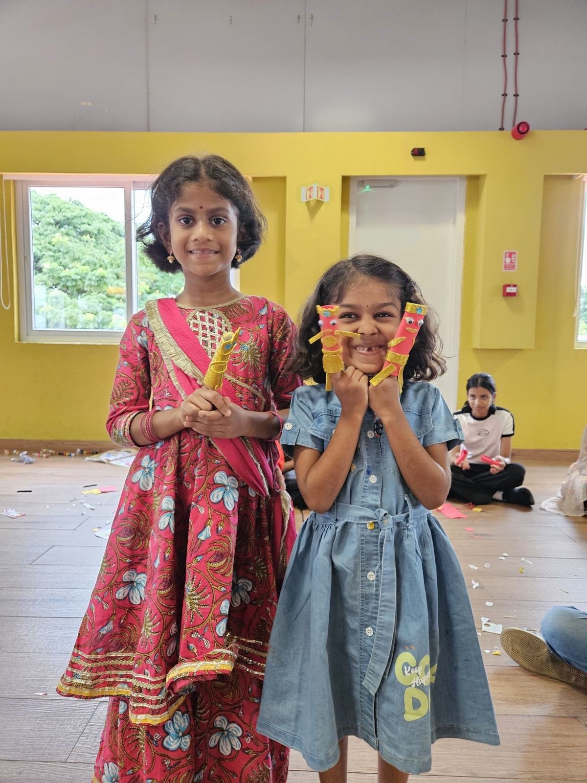 Two friends showing their crafts together