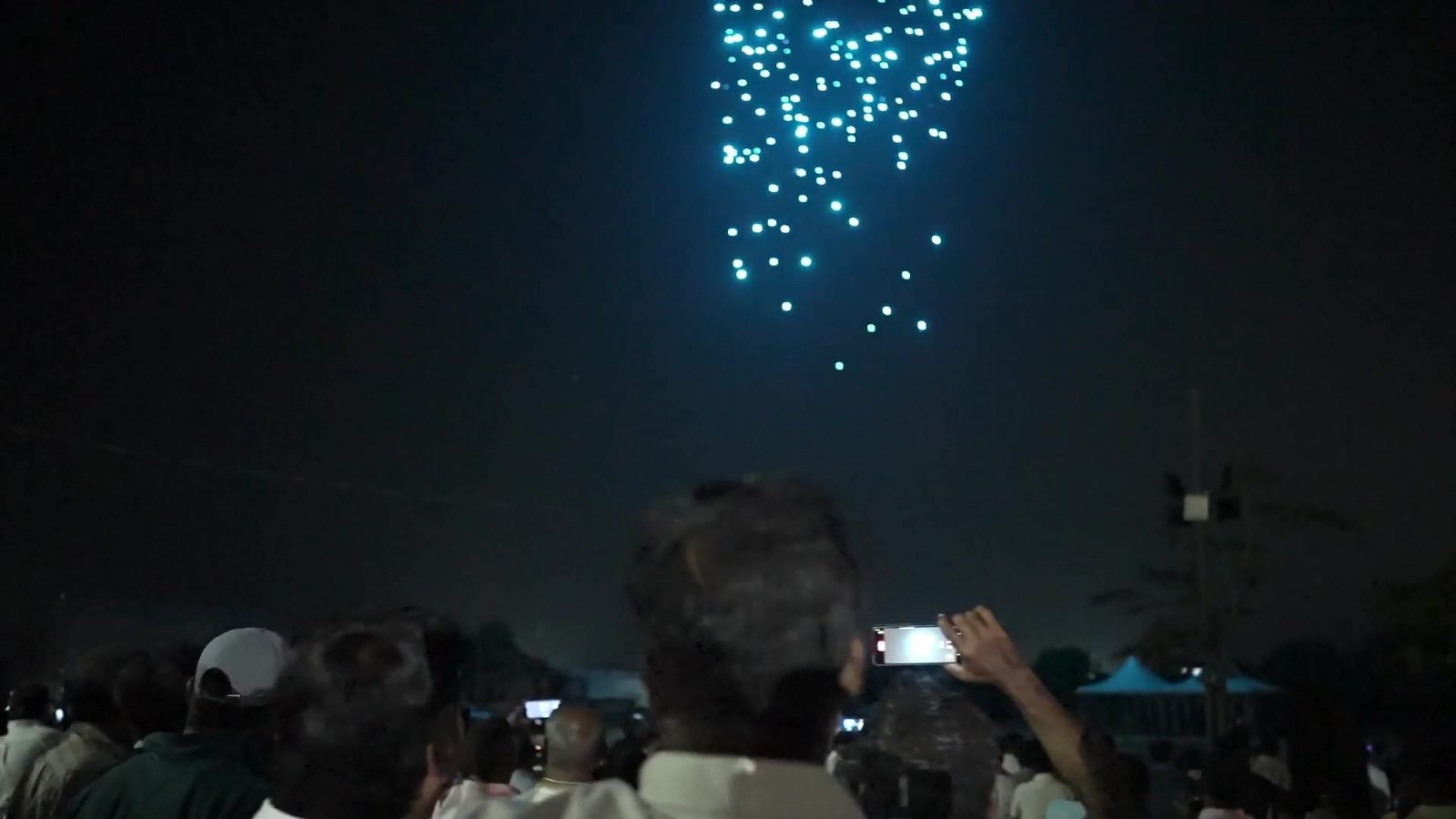 The crowd in Panruti filming the drones on their phones