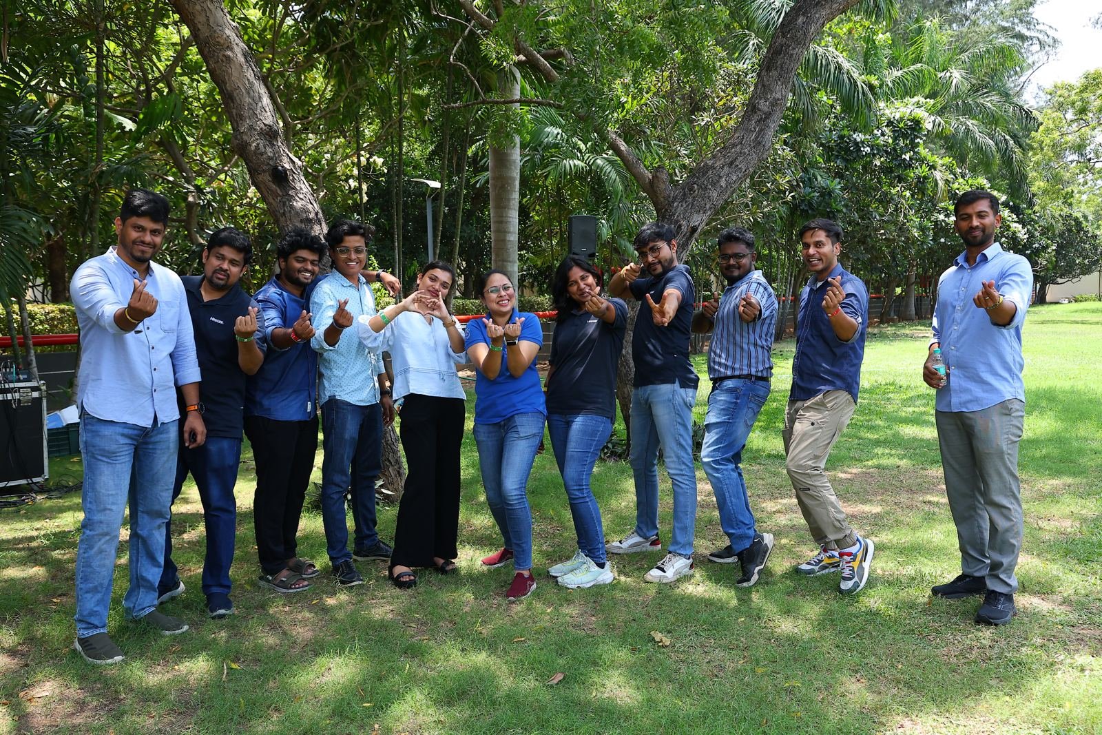 The Vestas GSS team making finger hearts together on the lawn