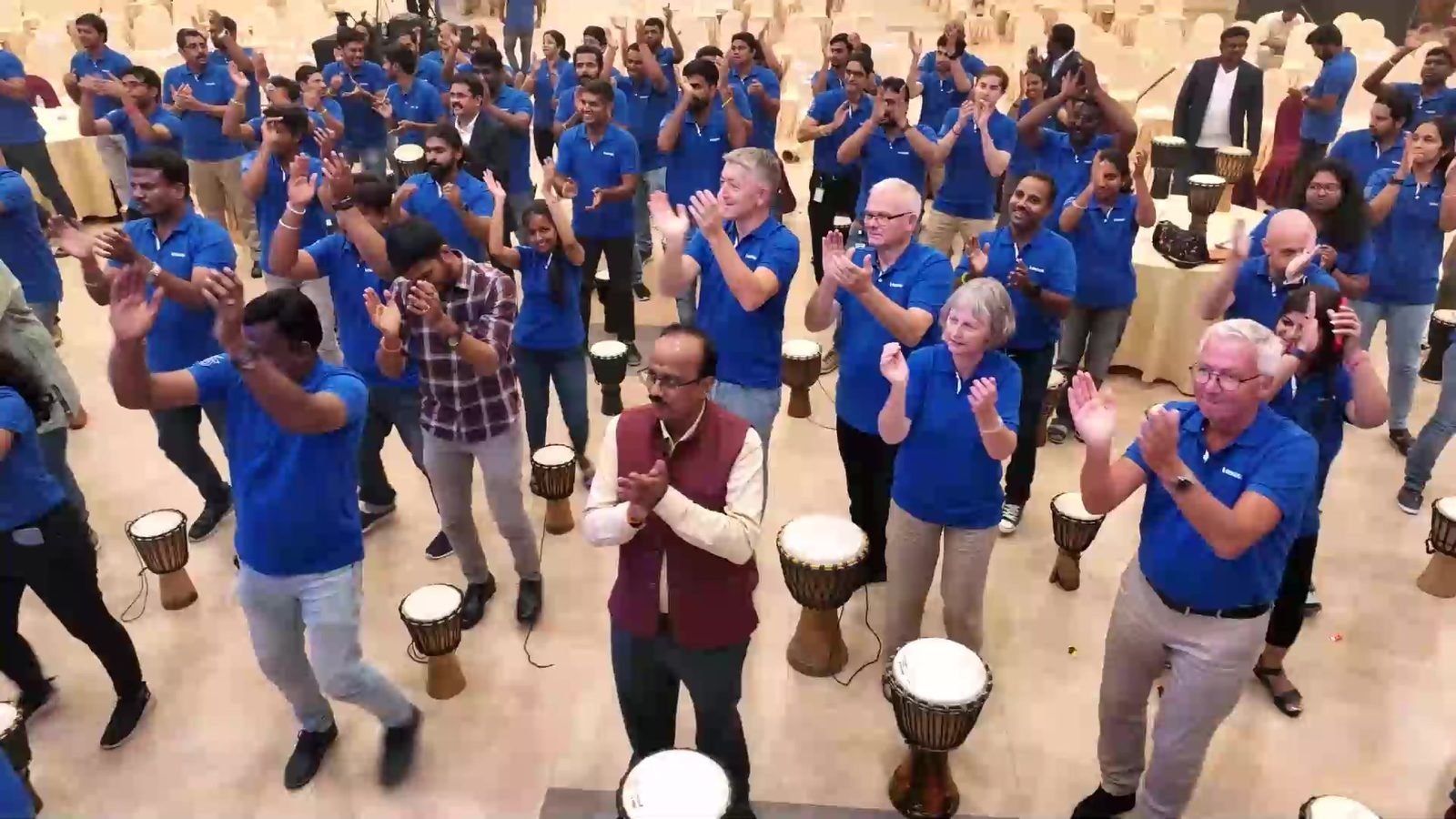 Vestas colleagues clapping and dancing in a drum circle