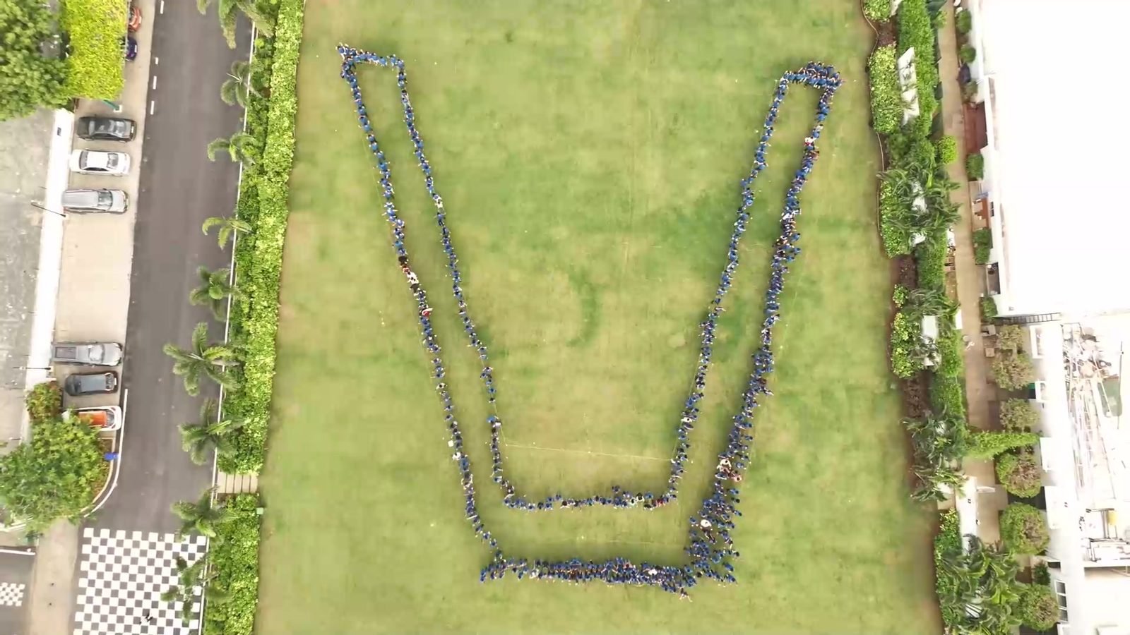 Vestas colleagues forming a giant human V on the lawn, seen from above