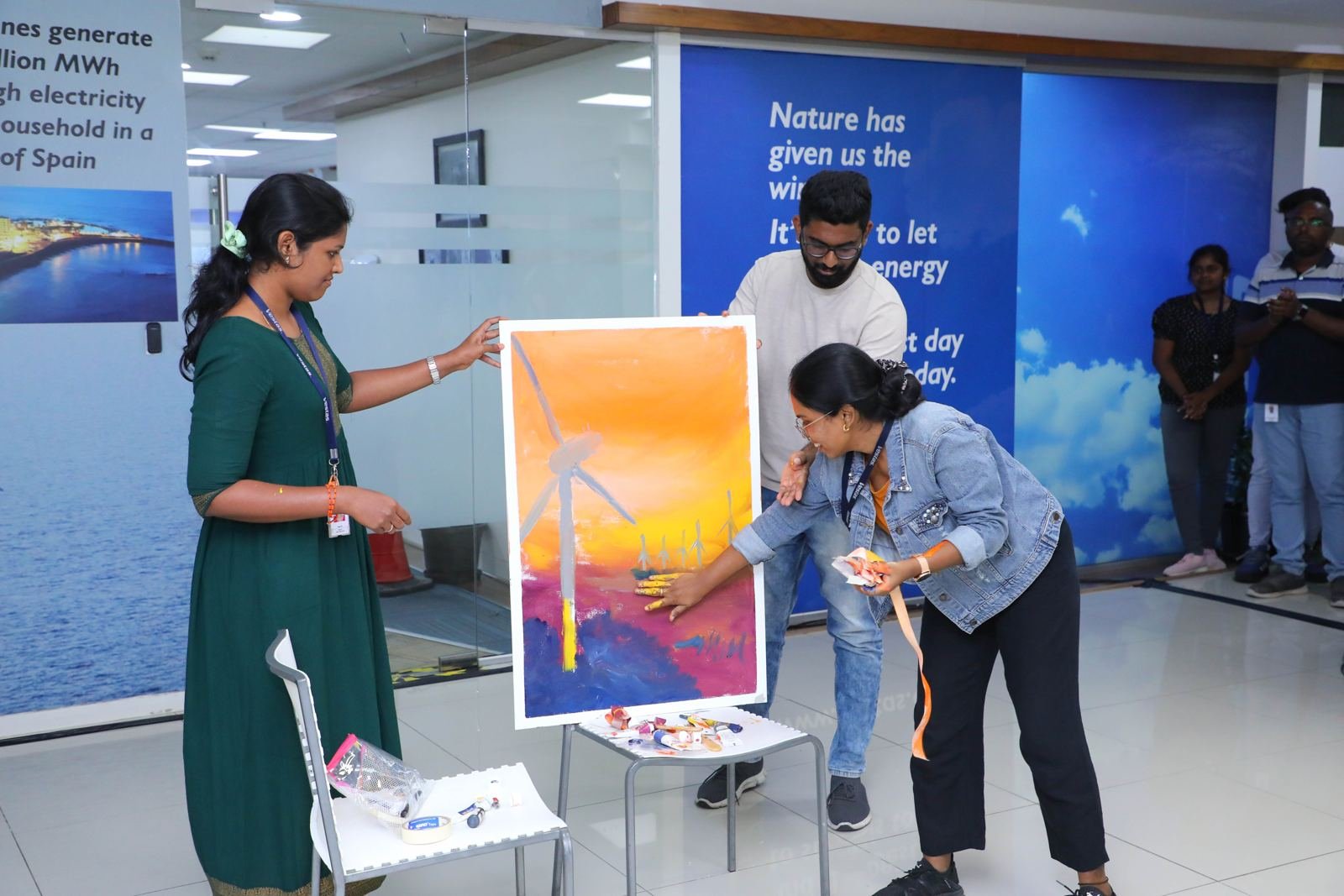 A participant presenting her team's artwork during a workshop